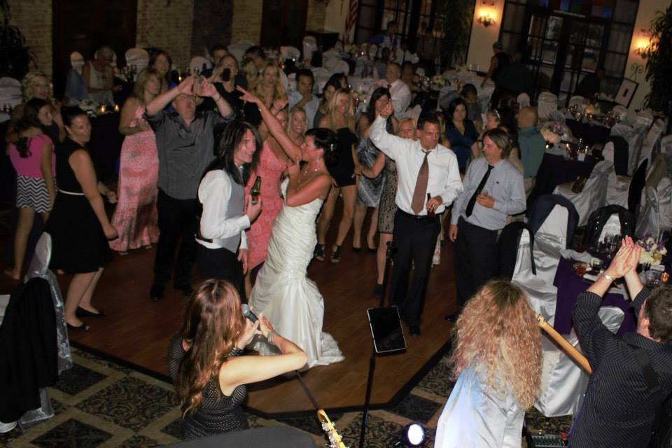 A group of people dancing in the middle of a room.